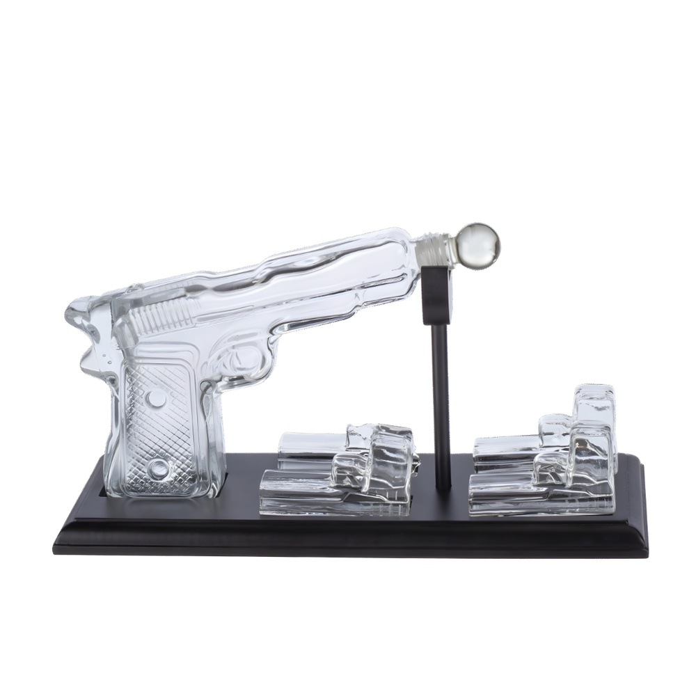 Pistol Whiskey Decanter Set featuring a unique pistol-shaped decanter and crystal glasses on a display stand.