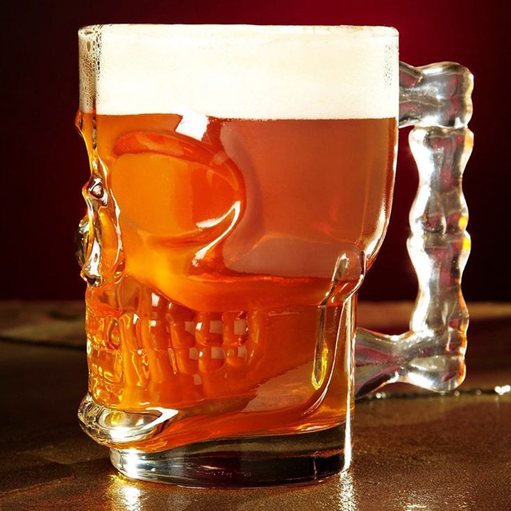 Skull Face Drinking Mug with glass handles for a spooky look.