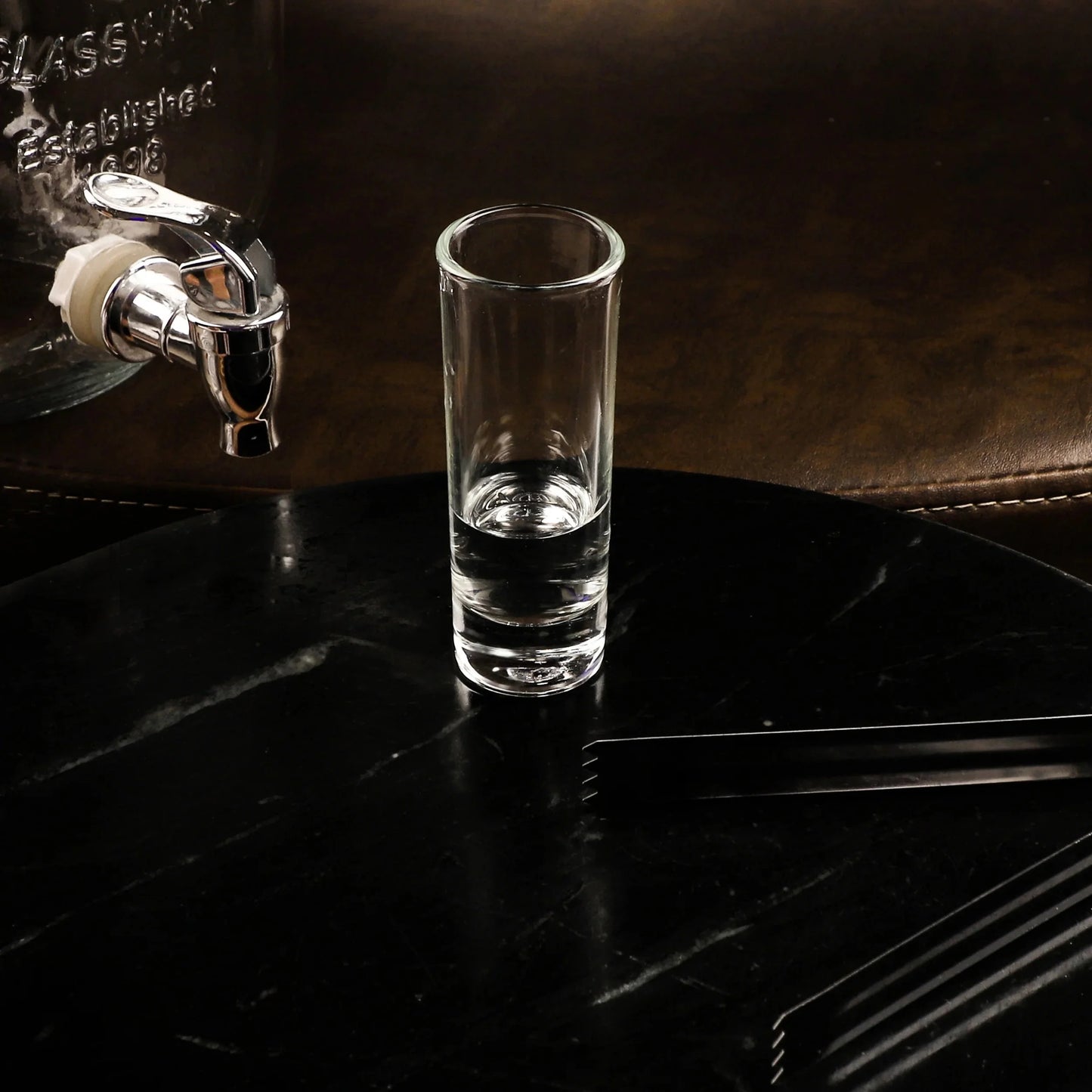 Vodka Tequila Shot Glass set from the side, highlighting its elegant shape and clarity.