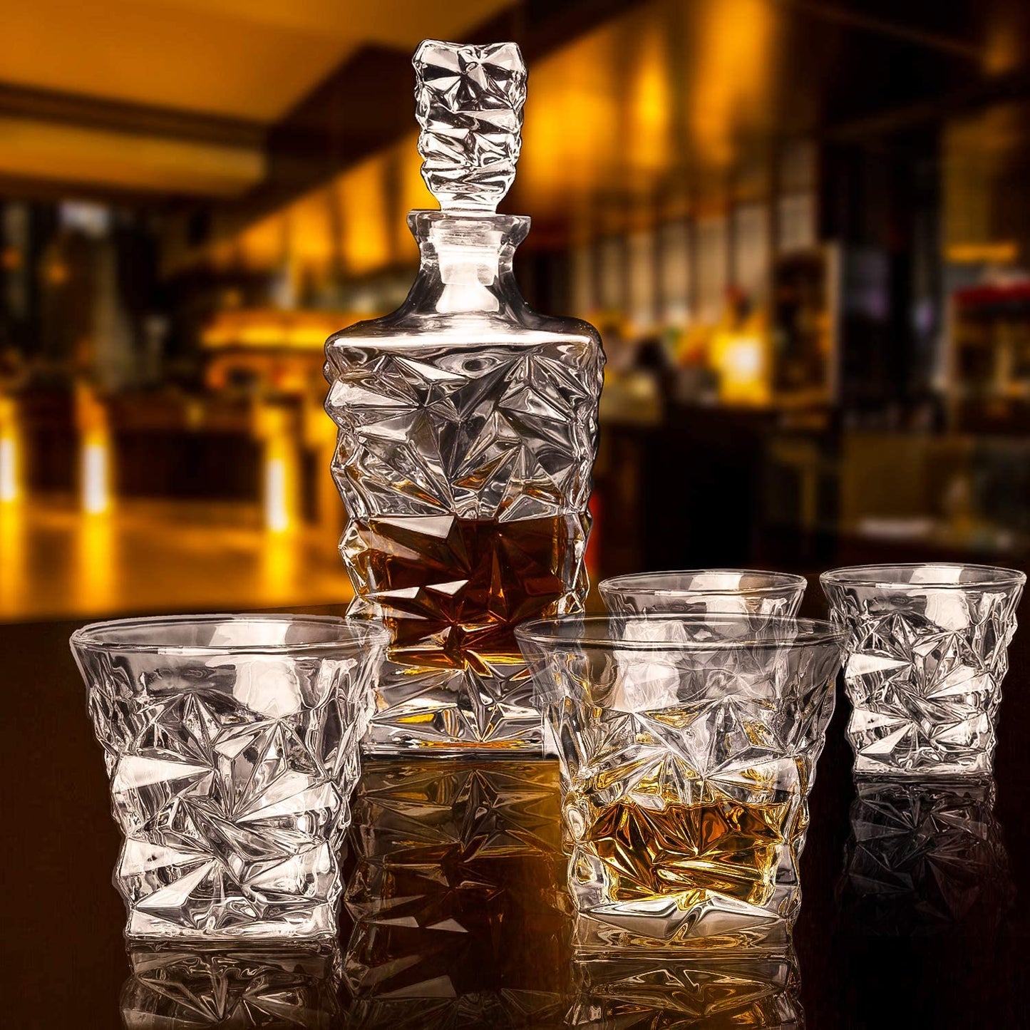 Crystal whiskey decanter set with four matching glasses on a bar table, modern design