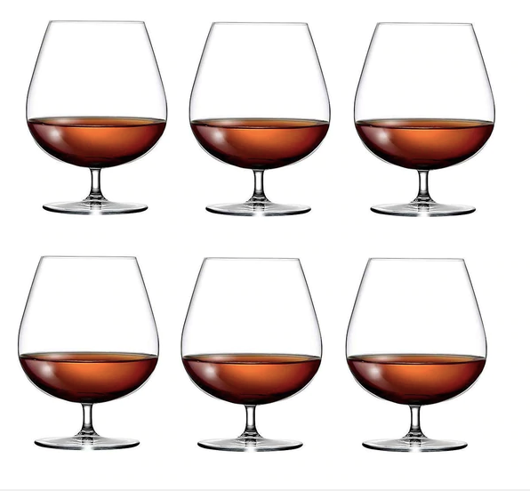 Set of six clear whiskey glasses with amber liquid, classic barware for home bar.